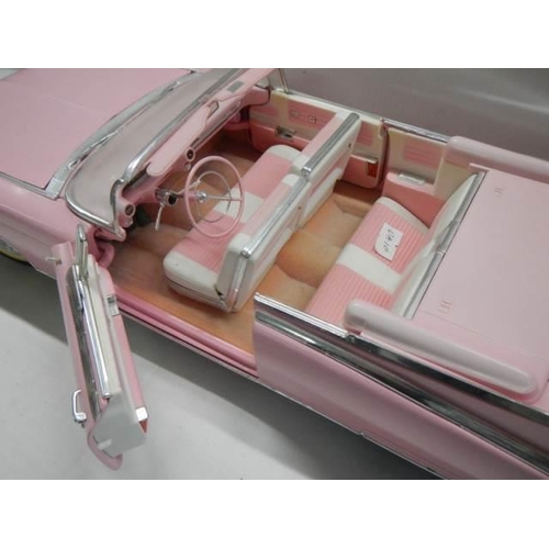 327 - A 1/12 scale pink Cadillac car.