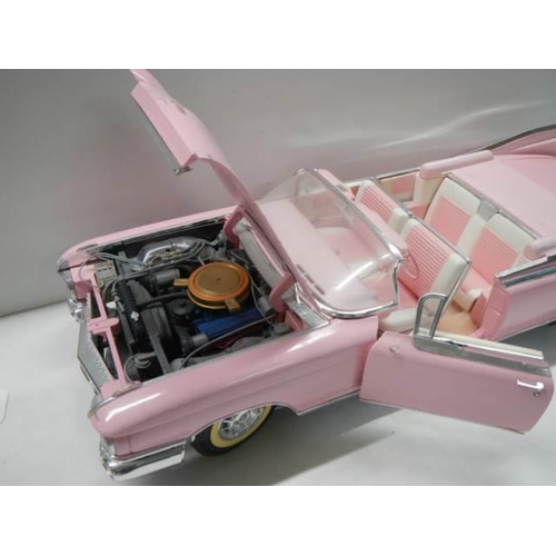 327 - A 1/12 scale pink Cadillac car.