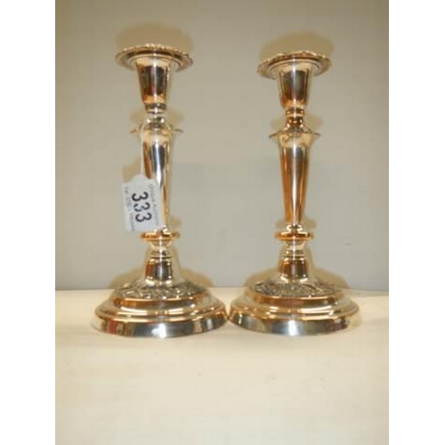 333 - A pair of Sheffield plate candlesticks (considerable plate wear).