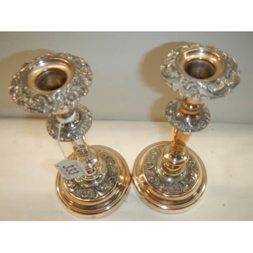 333 - A pair of Sheffield plate candlesticks (considerable plate wear).