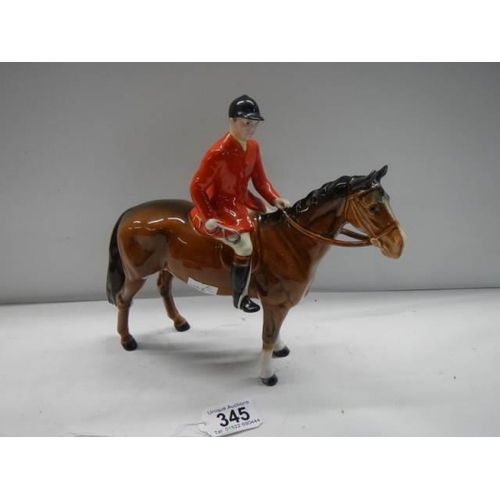 345 - A Beswick horse with red jacket huntsman, 22 cm