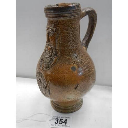 354 - A 'Bachanalian' salt glaze jug (possibly 18th century). This is a Bellarmine jug possibly 17th rathe... 