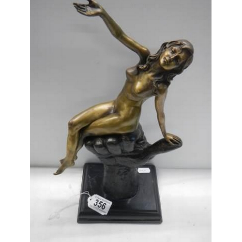 356 - A bronze nude figure sat on a clenched hand on a marble base marked Juno,  22.5 cm tall.