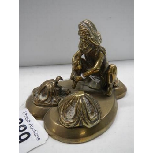 389 - An antique brass figure of a snake charmer.