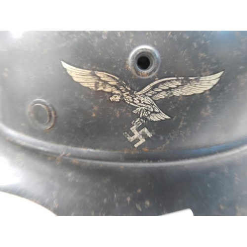 392 - A WW2 German Luftwaffe beaded helmet stamped NS64 DN30 with 'Ski Div Jungvolki' on liner and paper l... 