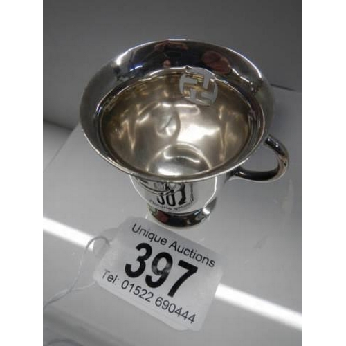 397 - A small two handled silver cup with Swastika symbol.