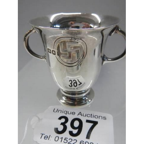 397 - A small two handled silver cup with Swastika symbol.