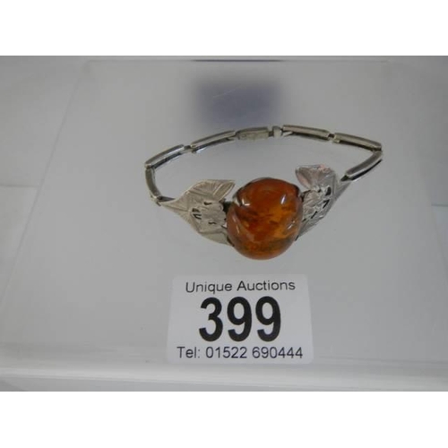 399 - A Danish silver bangle set amber.