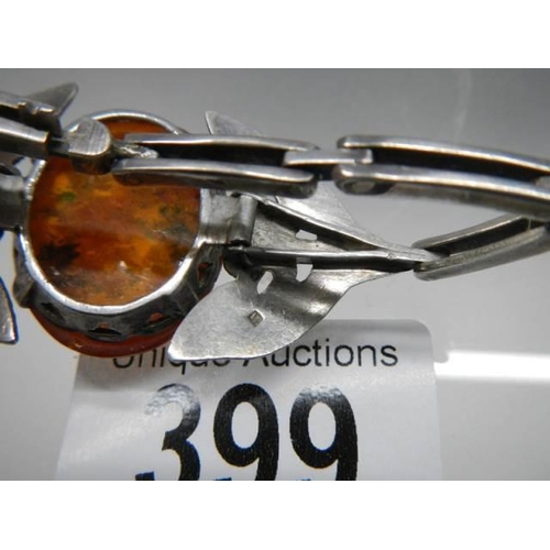 399 - A Danish silver bangle set amber.