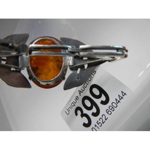 399 - A Danish silver bangle set amber.