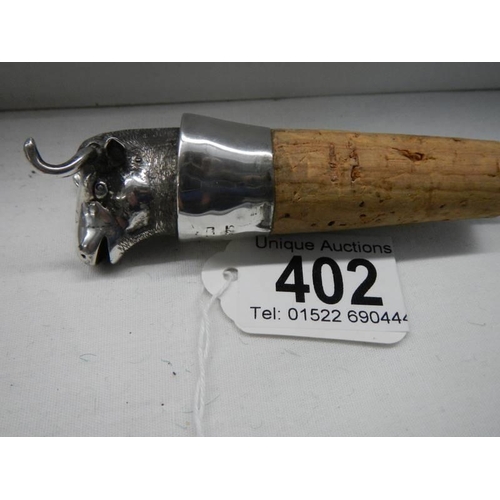 402 - A silver wine stopper in the form of a bulls head.