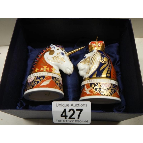 427 - A boxed pair of Royal Worcester candlesnuffers - The Lion and The Unicorn.