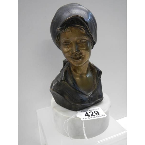 429 - A bronze bust of a female marked P M Milano, 20cm tall.