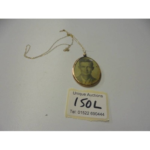 150L - A 9ct gold double sided photo locket on a 9ct gold chain.