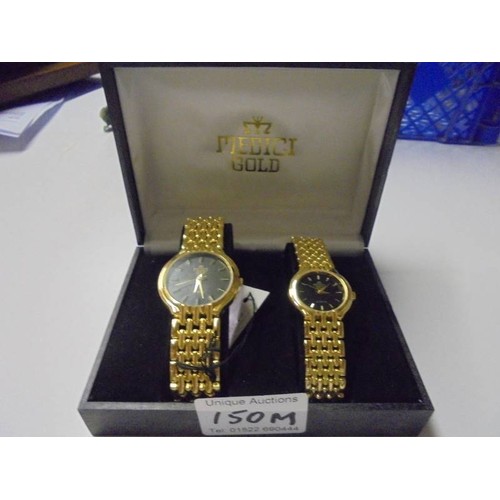 150M - A boxed pair of ladies/gents Medici 18ct gold plated wrist watches.