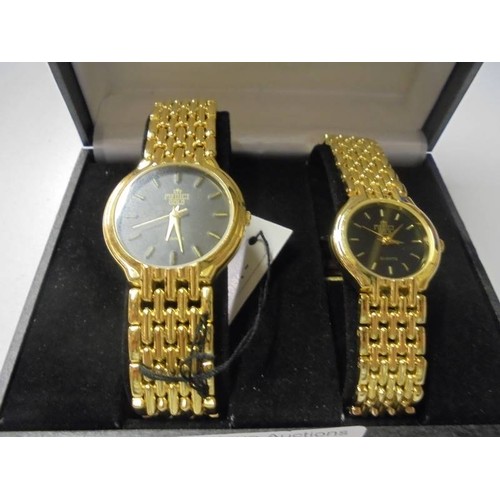 150M - A boxed pair of ladies/gents Medici 18ct gold plated wrist watches.