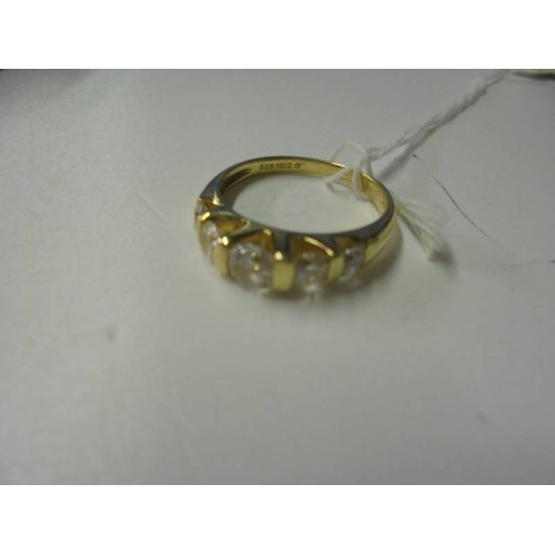 150U - A silver gilt ring set five clear stones, size P.