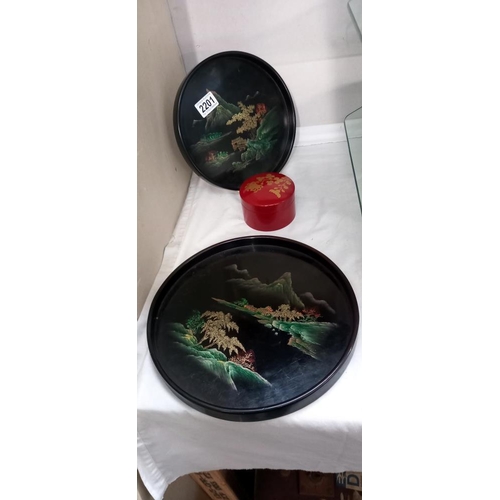 2201 - 2 Oriental scenes on black lacquered trays and red lacquered box of coasters, could also be used as ... 