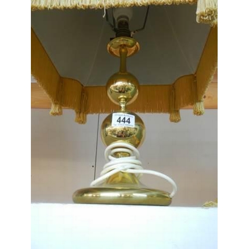 444 - A good quality brass table lamp with fringed shade.