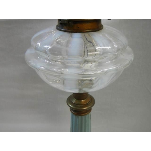 452 - A Victorian brass and metal oil lamp with opaque glass font, Duplex burner and later shade. COLLECT ... 