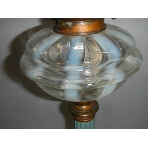 452 - A Victorian brass and metal oil lamp with opaque glass font, Duplex burner and later shade. COLLECT ... 