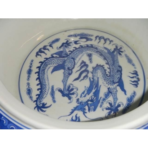 455 - A Chinese blue and white bowl decorated with dragons.