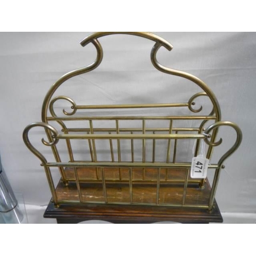 471 - An early 20th century brass magazine rack on a wooden base.