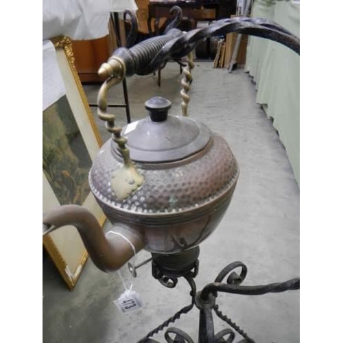 473 - An early 20th century copper kettle on a wrought iron stand, COLLECT ONLY.