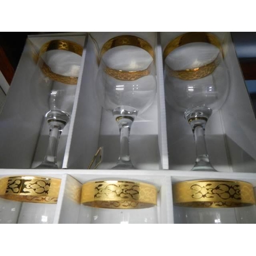 480 - A boxed set of six good quality gilt edged wine glasses.