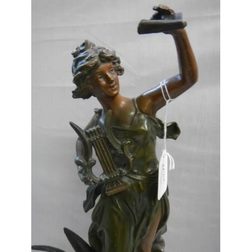 509 - A bronzed effect figure of a female harpist.