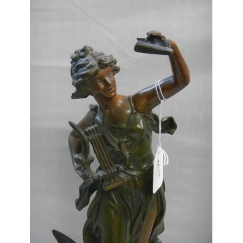 509 - A bronzed effect figure of a female harpist.