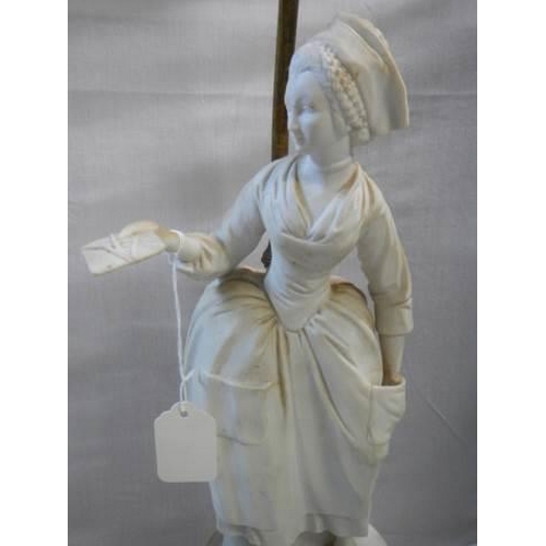 521 - An early 20th century table lamp featuring a parian figure, height to top of shade holder 90 cm, to ... 