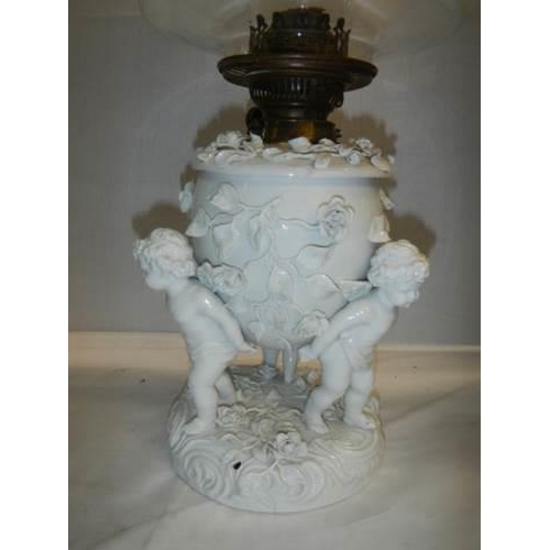 528 - A superb quality white glazed porcelain oil lamp surmounted with cherubs and with drop in font, COLL... 