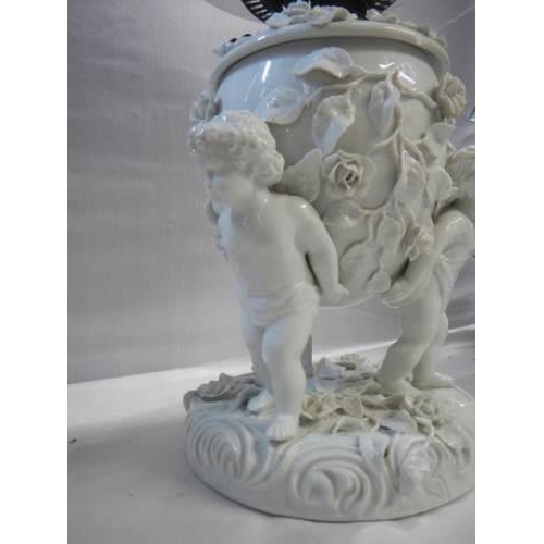 528 - A superb quality white glazed porcelain oil lamp surmounted with cherubs and with drop in font, COLL... 