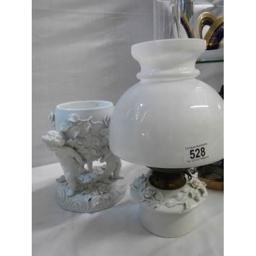 528 - A superb quality white glazed porcelain oil lamp surmounted with cherubs and with drop in font, COLL... 