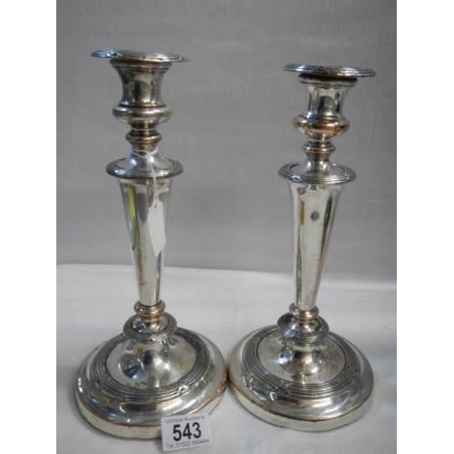 543 - A pair of silver plate on copper candlesticks.