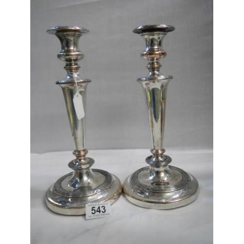 543 - A pair of silver plate on copper candlesticks.