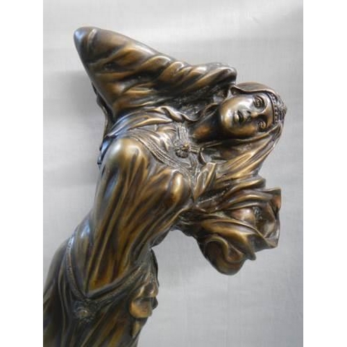 558 - A tall bronze figure of a female.