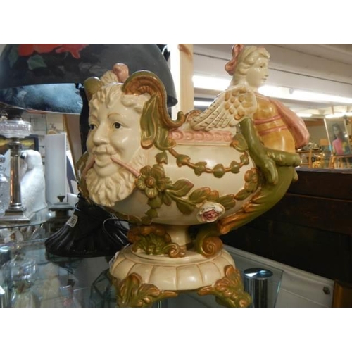 562 - A 20th century jardiniere featuring surmounted figures, in good condition.