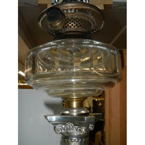 573 - A Victorian silver plate Corinthian column oil lamp in good condition.