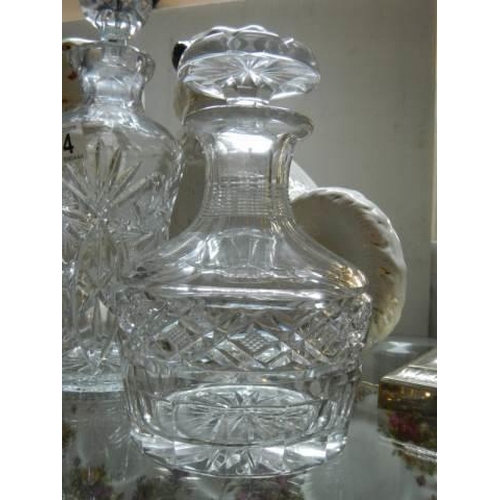 574 - A pair of matching decanters and one other.