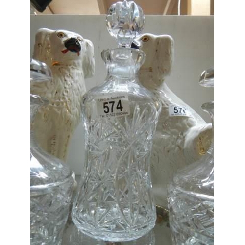 574 - A pair of matching decanters and one other.