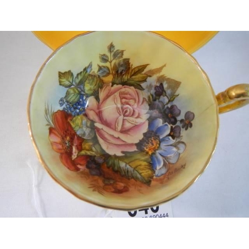 640 - An Aynsley Cabbage Rose pattern tea cup and saucer signed J A Bailey (saucer has slight fault.)