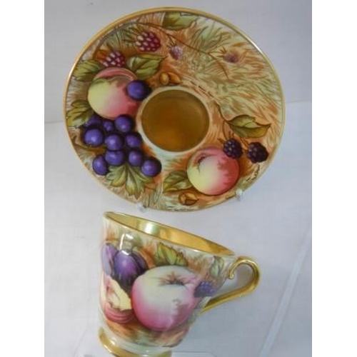 642 - An Aynsley Orchard Gold Demitasse cup and saucer signed N Brunt.