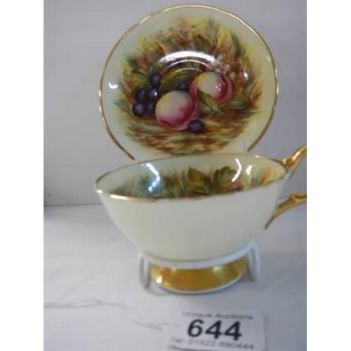 644 - An Aynsley Orchard Gold Apricot cup and saucer with gold footing signed D Jones.