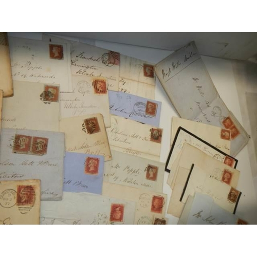 680 - Approximately 65 penny red stamps on postmarked envelopes.