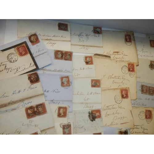 680 - Approximately 65 penny red stamps on postmarked envelopes.