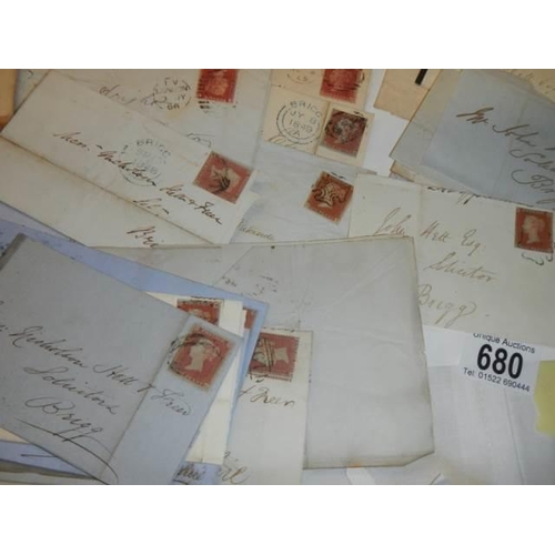 680 - Approximately 65 penny red stamps on postmarked envelopes.