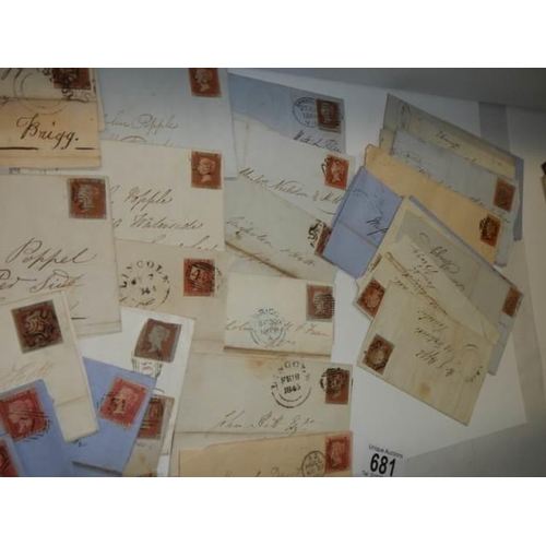 681 - Approximately 40 penny red stamps on postmarked envelopes.