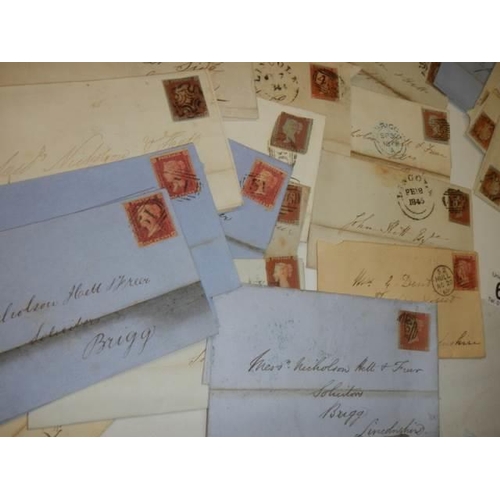 681 - Approximately 40 penny red stamps on postmarked envelopes.